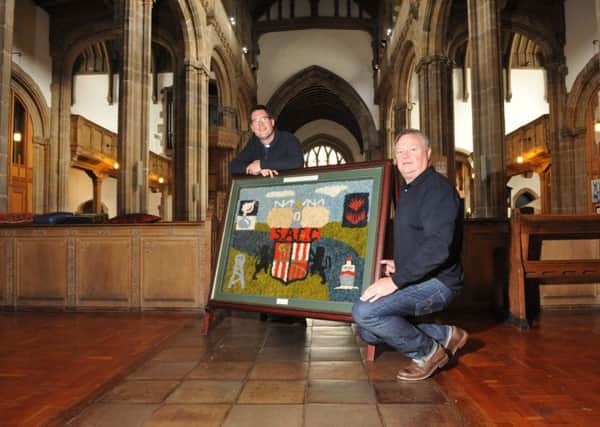 Sunderland Fans Museum's Michael Ganley, right, and the Rev Andrew Dowsett, with the dried flower artwork in memory of Wearmouth Colliery miners.