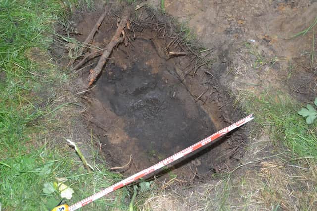 The shallow grave behind a dry-stone wall where Darren Bonner was found.