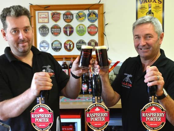From left head brewer, Glen Whale and owner Mark Anderson toast Raspberry Porter's success.