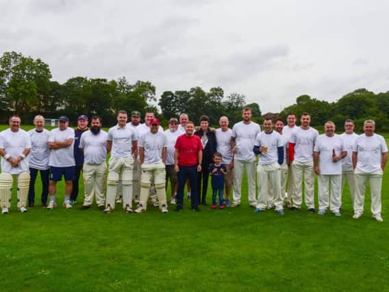 The players in Veterans in Crisis (VICs) T-shirts before this year's match.