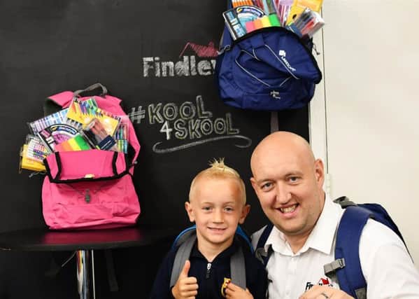 Grant Findley with his son Jayden showing off some of the Kool 4 Skool packs.