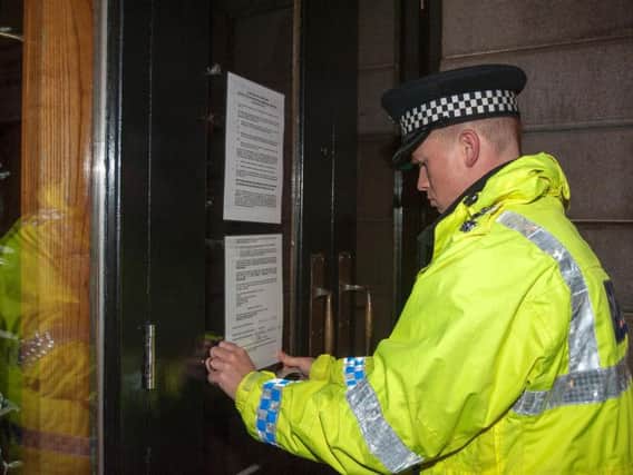 Police issuing a closure notice to a city centre bar.