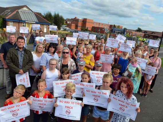 Campaigners demonstrate against the hostel plan.