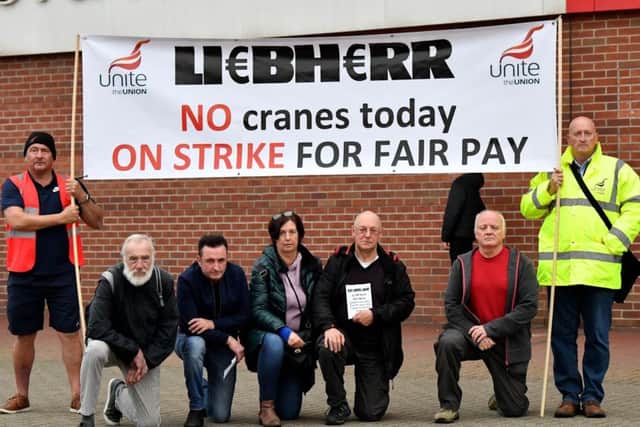 Unite Union Regional Officer Mark Sanderson (right) with strikers and protesters outside of The Stadium of Light . Picture by FRANK REID