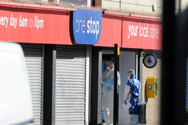 Forensics officers enter the One Stop shop in Sunderland as a murder investigation continues