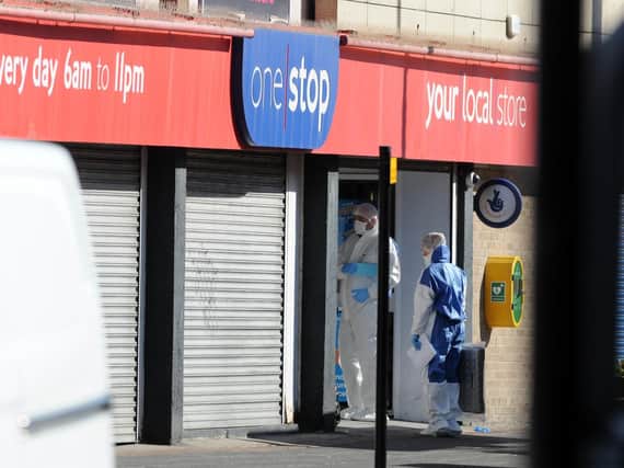 Forensics officers enter the One Stop shop in Sunderland as a murder investigation continues