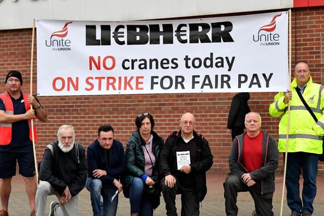 Unite Union Regional Officer Mark Sanderson (right) with strikers and protesters outside of The Stadium of Light