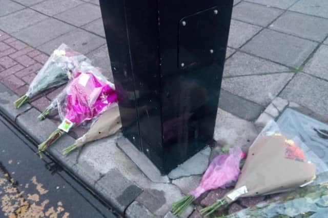 Flowers have been laid near the shop in Sea Road.