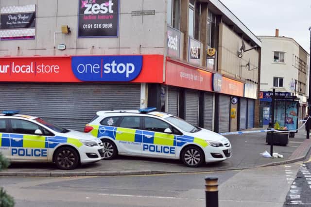 Police remain on guard outside the One Stop shop in Sea Road, Fulwell.