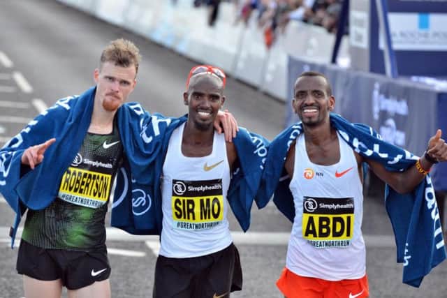 Record-breaking five-times Great North Run winner Sir Mo Farah, centre, with second-placed Jake Robertson, left, and Bashir Abdi, who finished third.