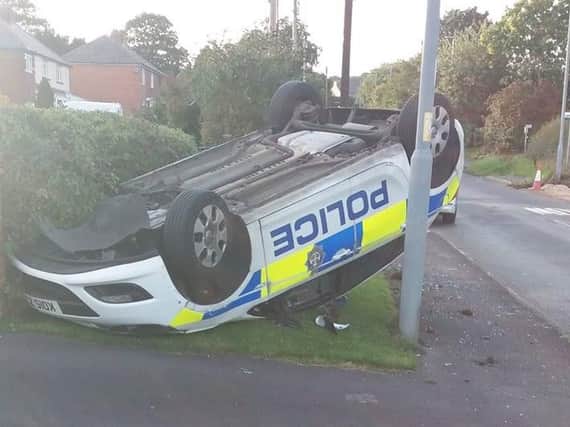 The police car landed on its roof