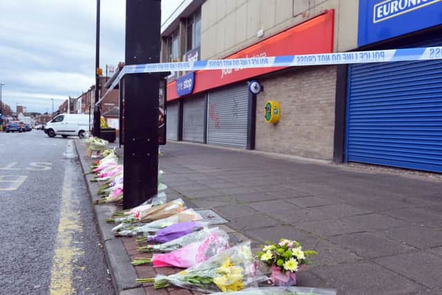 Floral tributes to Joan Hoggett outside the One Stop shop in Sea Road.