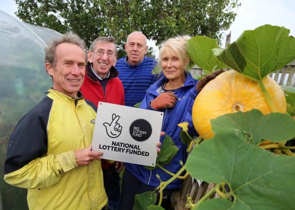 Gardeners Tim Wright, Charlie Horton, Bob Redpath and Marina Birkelbach celebrate their grant from the National Lottery. Picture by Tom Banks.
