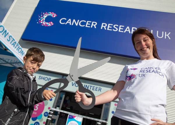 Lisa McGlynn and son Harrison open the new Cancer Research UK store at Pallion Retail Park.