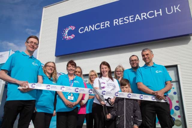 Lisa McGlynn, centre, and son Harrison at the opening of the new Cancer Research UK store at Pallion Retail Park.