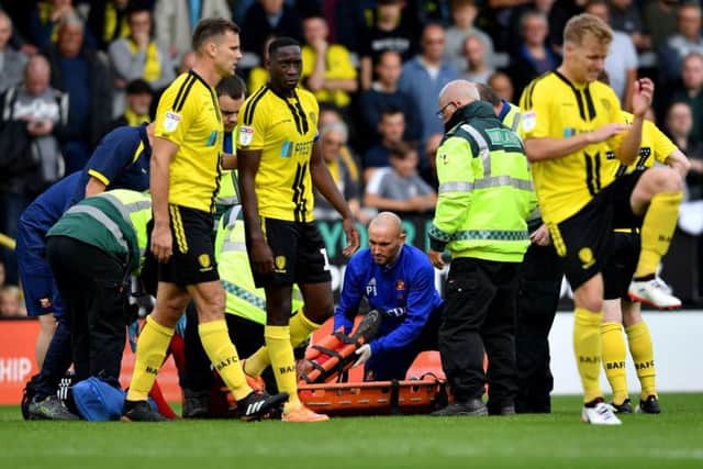 Charlie Wyke is carried from the field on a stretcher.