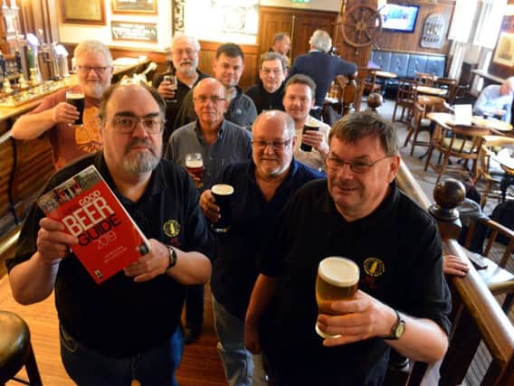 Fitzgeralds pub celebrates 25 years in the Camra Good Beer Guide. Front from left, North East Camra director David Brazer and chair of Sunderland and South Tyneside Camra Michael Wynne.