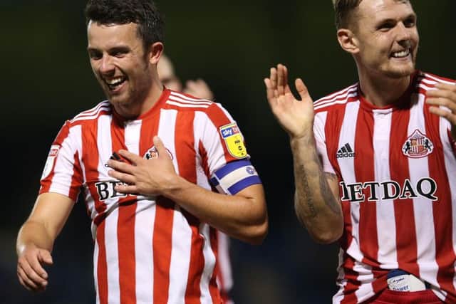 Sunderland skipper George Honeyman pictured with Max Power.