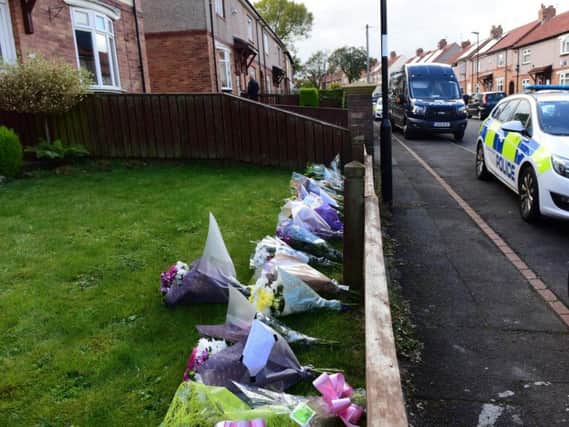 Floral tributes left outside the house in Shrewsbury Crescent.