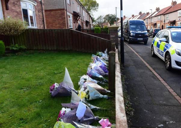 Flowers left outside a house in Shrewsbury Crescent where the bodies of Kay Michelle Martin and Alan Matthew Martin were found last Thursday.