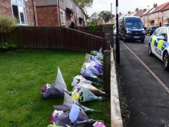 Floral tributes left outside the house in Shrewsbury Crescent
