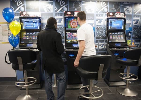 A punter on a new gambling machine in a betting shop. PA Archive/PA Images