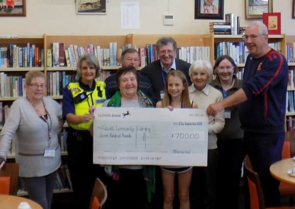 Jessica pictured presenting a cheque for Â£700 which she raised by taking part in the 4K Junior Great North Run.