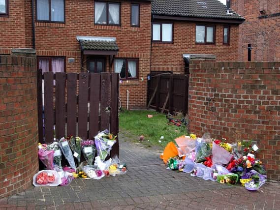 Floral tributes left at the scene of Scott's murder in 2004