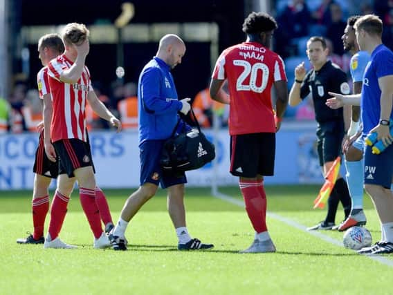 Sunderland defender Denver Hume leaves the field with a knee injury.