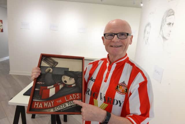 Frederick Street Gallery owner Ken Devine invites football fans to contribute art
