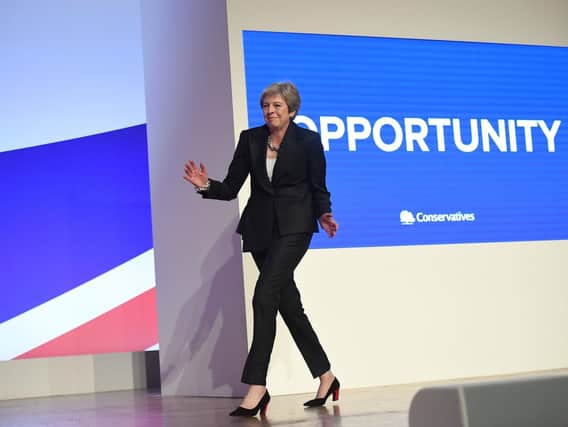 Prime Minister Theresa May dances as she arrives on stage to make her speech at the Conservative Party annual conference at the International Convention Centre, Birmingham
