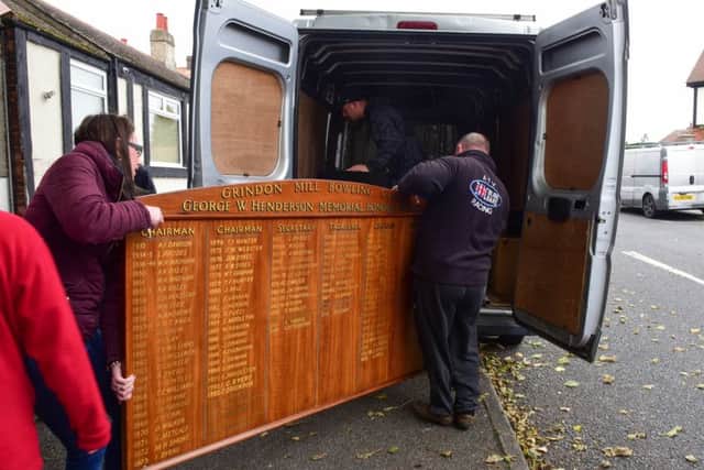 Members of Grindon Bowls Club, who are angry at being kicked out of their clubhouse on Grindon Lane, removing their honours board.