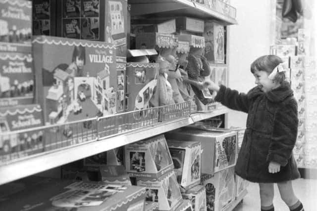 Helen Banks, 3, takes a close look at one of the displays in Joplings toy department in 1978.