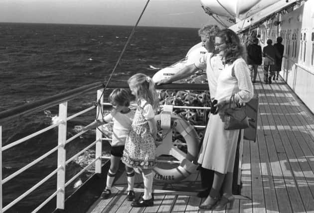 Andrea with mum, dad and brother on the deck of the MV England.
