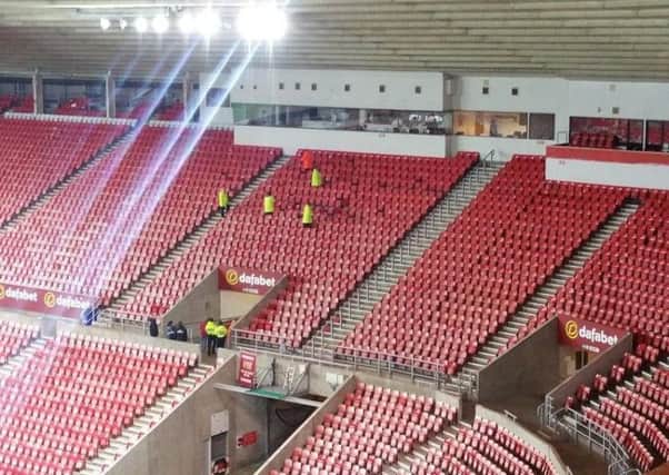 Stewards inspect damaged seats at the Stadium of Light after the game between Sunderland U23s and Newcastle United.