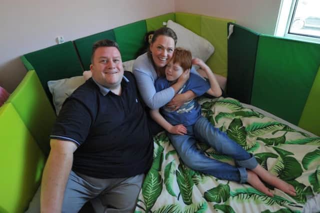 Peter Kelly and Victoria Edmundson-Brown with Benjamin in his room, which is fitted out with padding with a mattress on the floor so he doesn't get hurt if he falls out of bed.