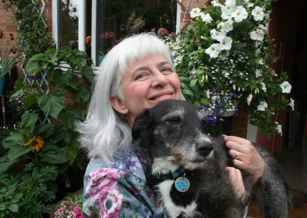Leda Gibbins in her garden with her dog Doris.