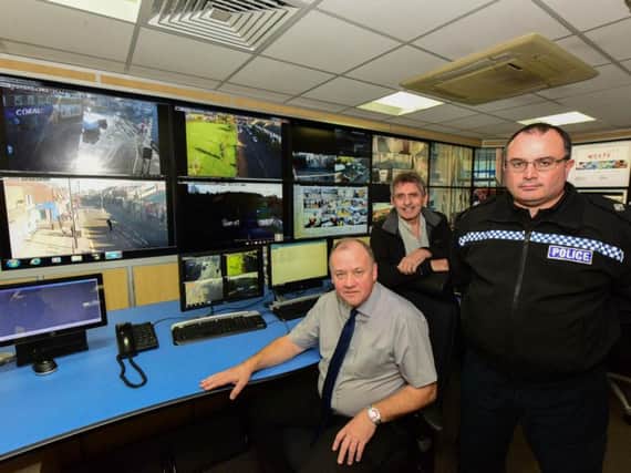 Coun Stephen Foster, ( seated ) with Northumbria Police Inspector Don Wade, and Coun Denny Wilson, viewing some of the CCTV pictures sent back to the civic centre