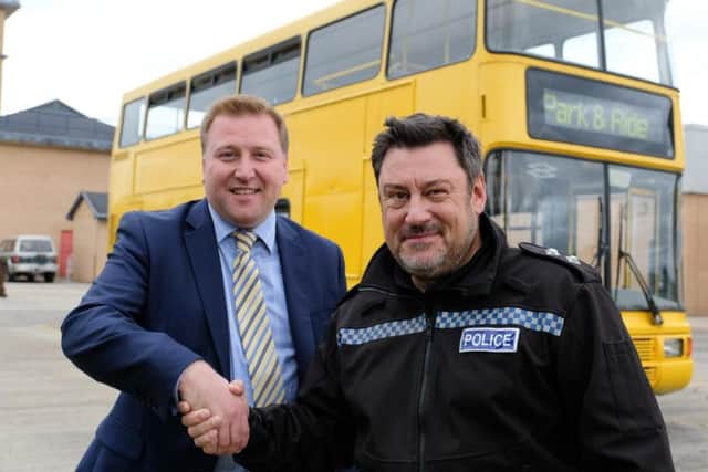 Stephen King from Go North East hands over the bus to Inspector Karl Brown.
