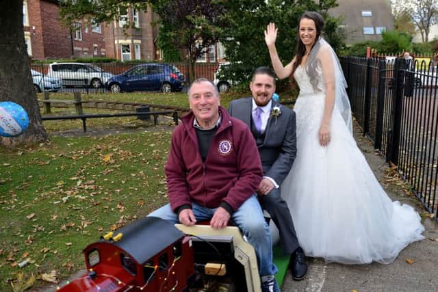 Wedding couple Chris and Rebecca Spokes on the miniature railway in Roker Park with train driver John Faulkner. Picture by FRANK REID