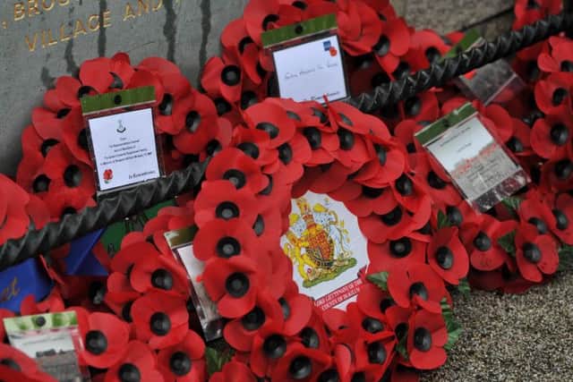 Poppy wreaths at the new memorial plaque