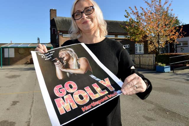 Molly's mum Louise Scott with one of the 'Support Molly' posters