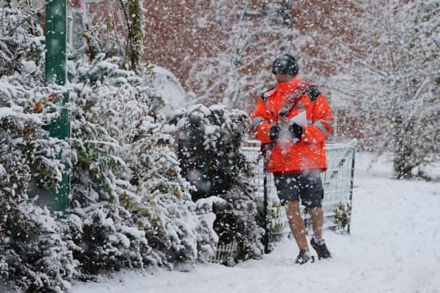 A postman in shorts delivers mail in the snow near Consett, County Durham. Pic: Owen Humphreys/PA Wire.