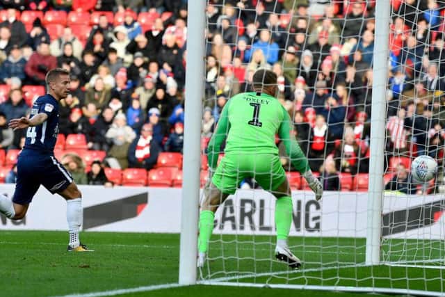 Southend's keeper can only look on as George Honeyman heads Sunderland in front.