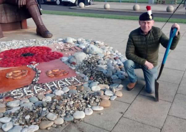 Dave McKenna with a previous pebble and shell display created in front of the Tommy statue by the Seaham Remember Then Fund.