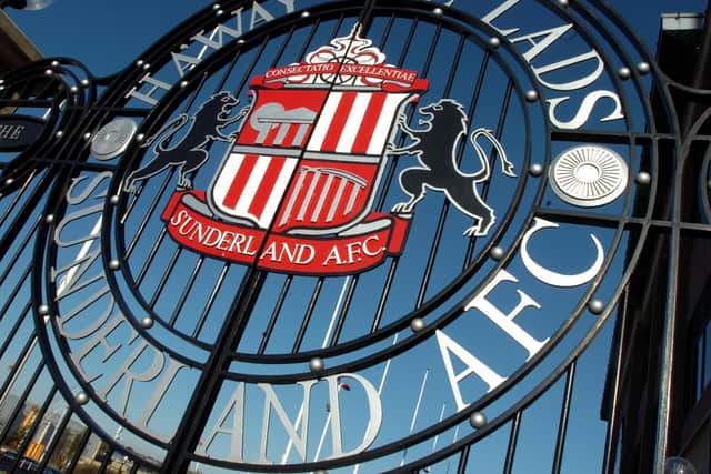 The stadium gates are adorned with the club badge.