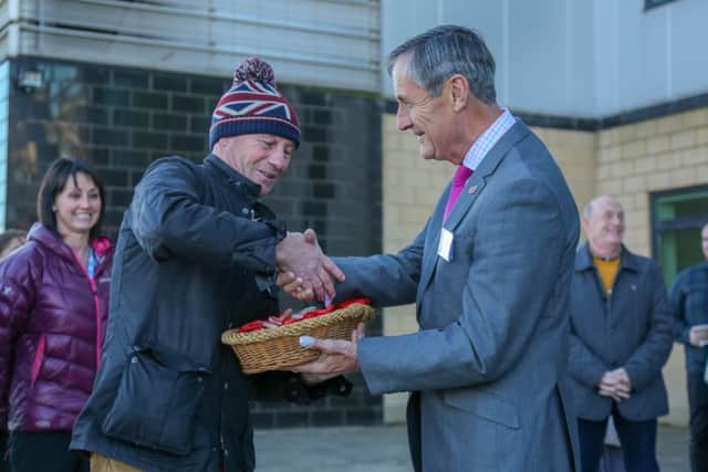 David McKenna is presented with some poppy pebbles by Alan Miller of the East Durham Trust. Picture: Tom Banks