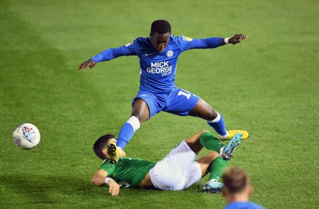 Peterborough United's Siriki Dembele is tackled by Brighton and Hove Albion U21's Mathias Normann during the Checkatrade Trophy, Southern Group H match at the ABAX Stadium, Peterborough. PRESS ASSOCIATION Photo. Picture date: Tuesday October 9, 2018. See PA story SOCCER Peterborough. Photo credit should read: Joe Giddens/PA Wire. RESTRICTIONS: EDITORIAL USE ONLY No use with unauthorised audio, video, data, fixture lists, club/league logos or "live" services. Online in-match use limited to 120 images, no video emulation. No use in betting, games or single club/league/player publications.