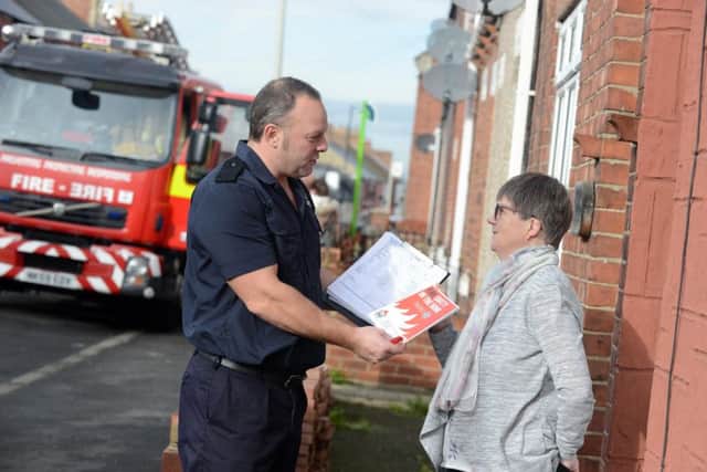 Firefighter Leigh Edgar with resident Joan Whitfield