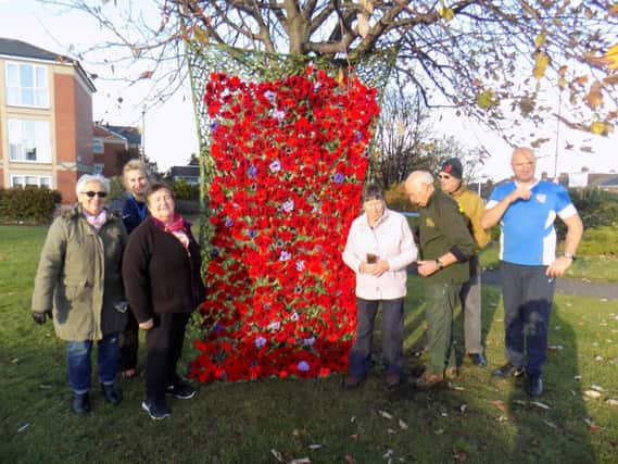 Knitted poppies pinned on nets for a Remembrance Service in Fulwell.